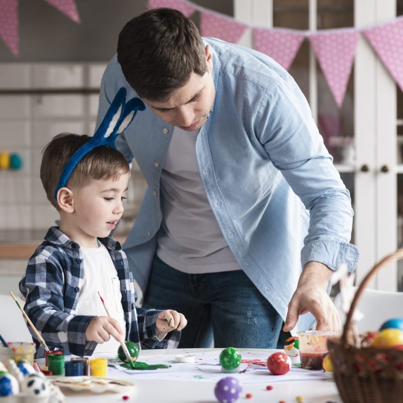 father-teaching-little-boy-how-paint-easter-eggs